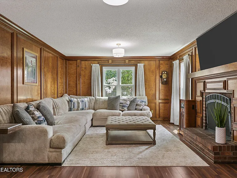 Family room with fireplace and wood paneling at 11016 Calloway View Dr