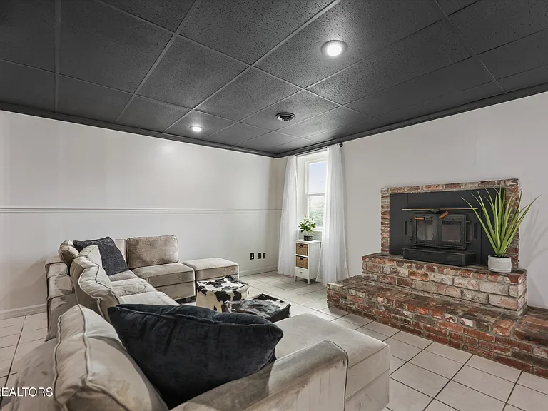 Basement fireplace with brick surround at 11016 Calloway View Dr